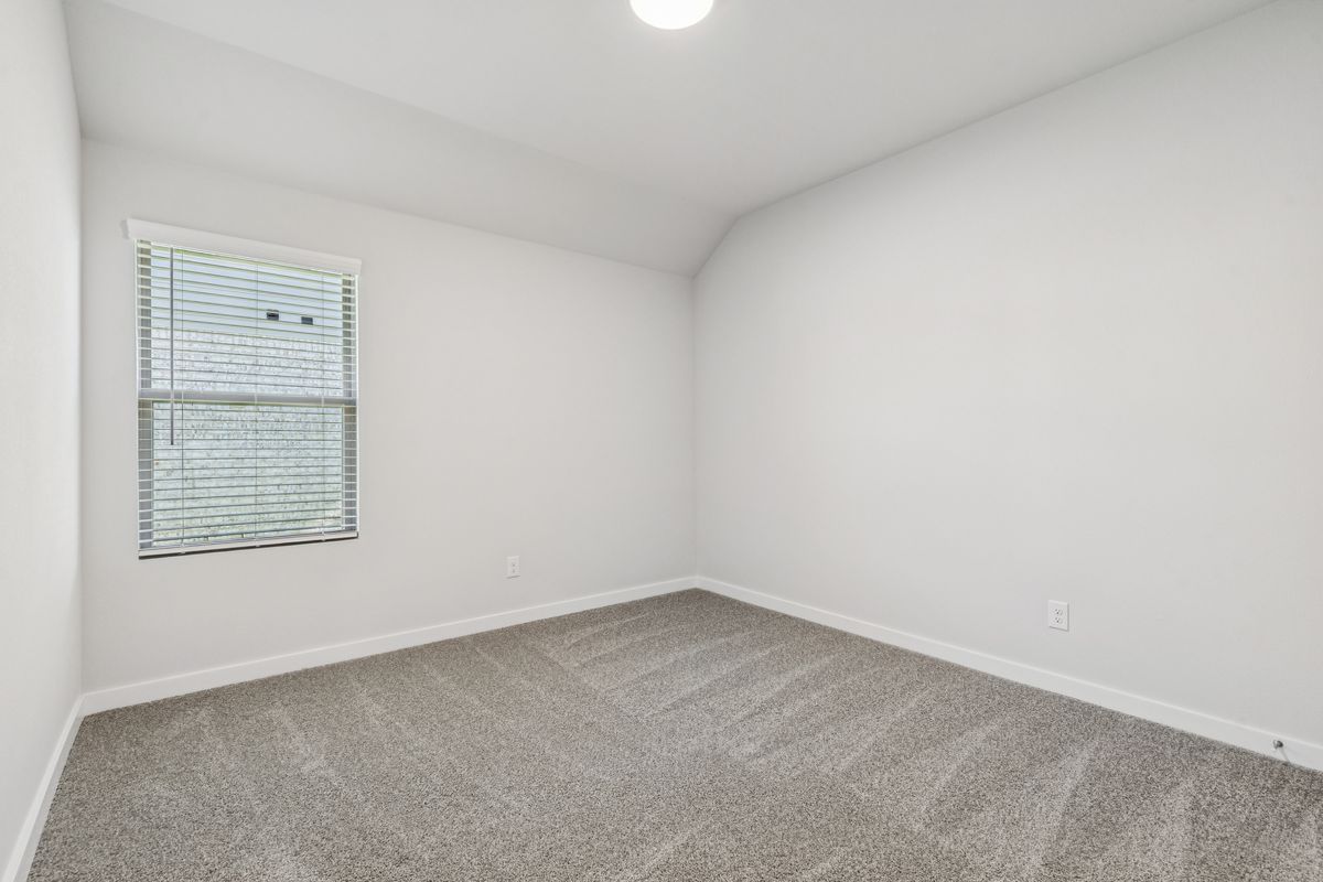 Bedroom in the Oscar home plan by Trophy Signature Homes – REPRESENTATIVE PHOTO