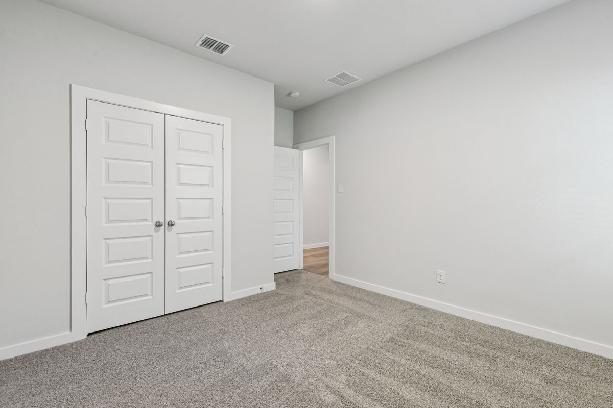 Bedroom in the Oscar home plan by Trophy Signature Homes – REPRESENTATIVE PHOTO