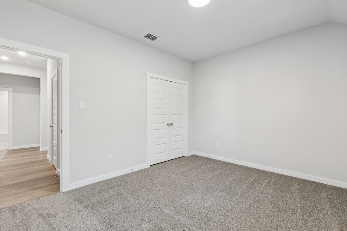 Bedroom in the Oscar home plan by Trophy Signature Homes – REPRESENTATIVE PHOTO
