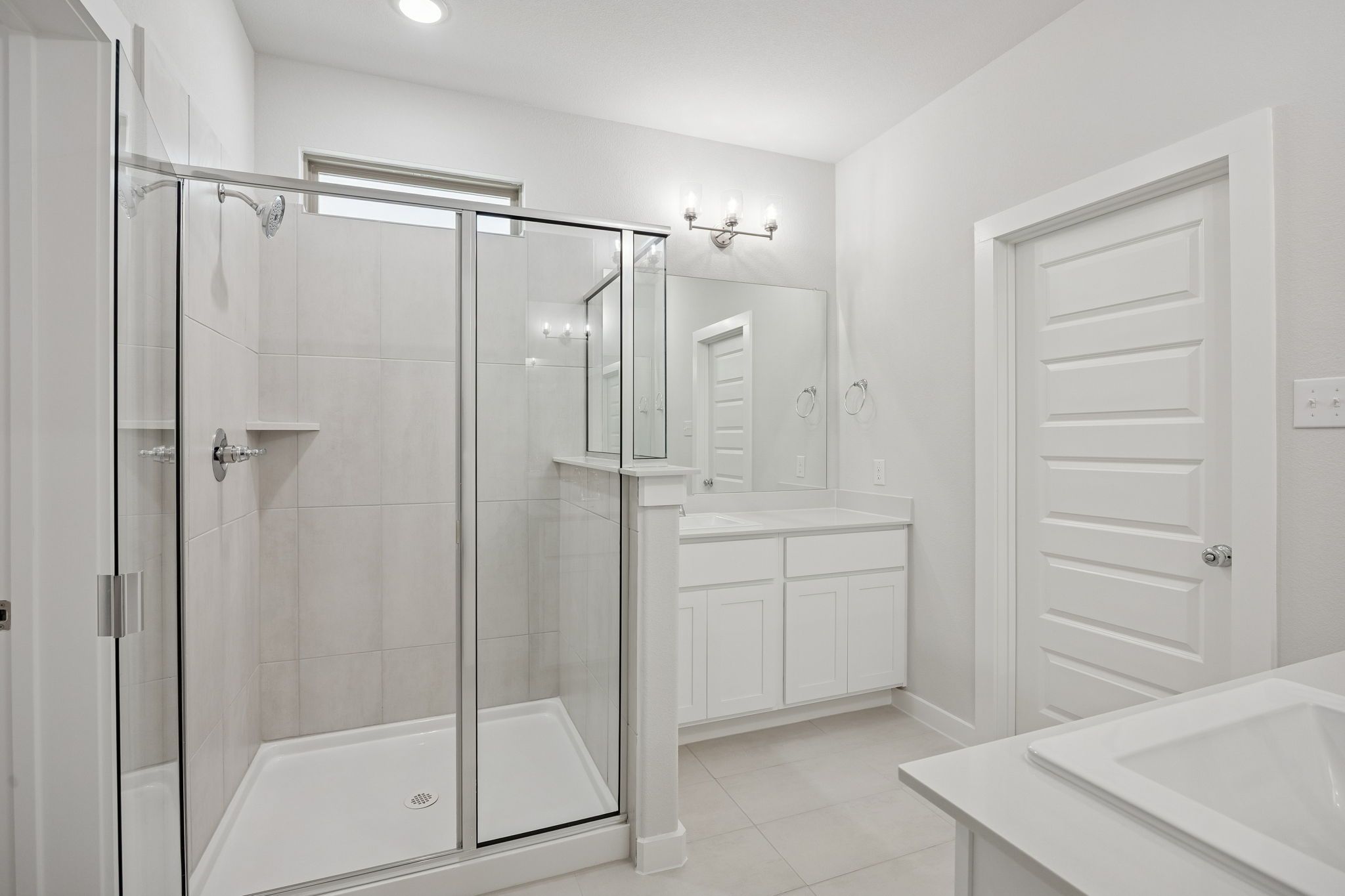 Primary Bathroom in the Masters home plan by Trophy Signature Homes – REPRESENTATIVE PHOTO