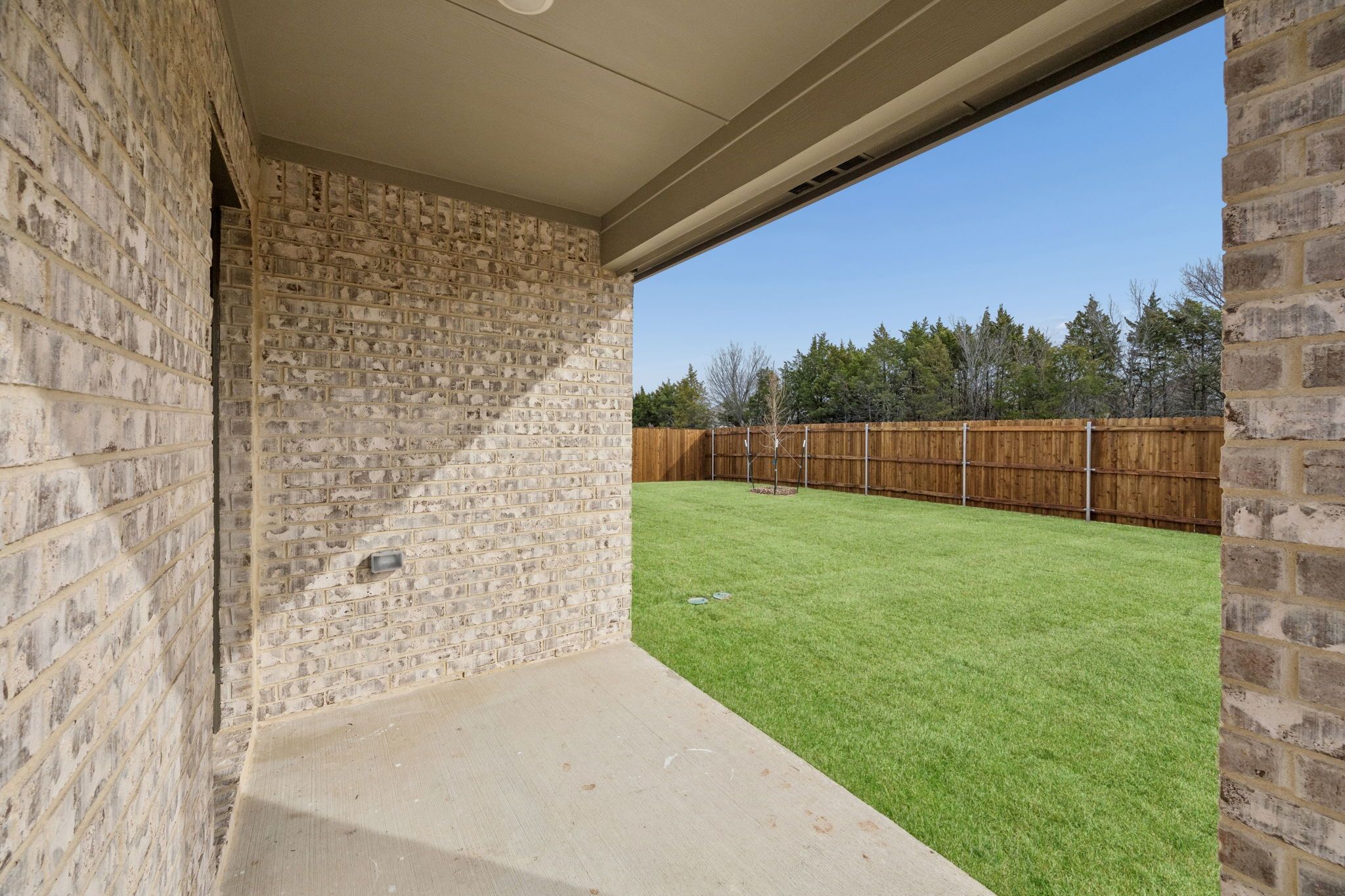 Covered Patio in the Heisman home plan by Trophy Signature Homes - REPRESENTATIVE PHOTO