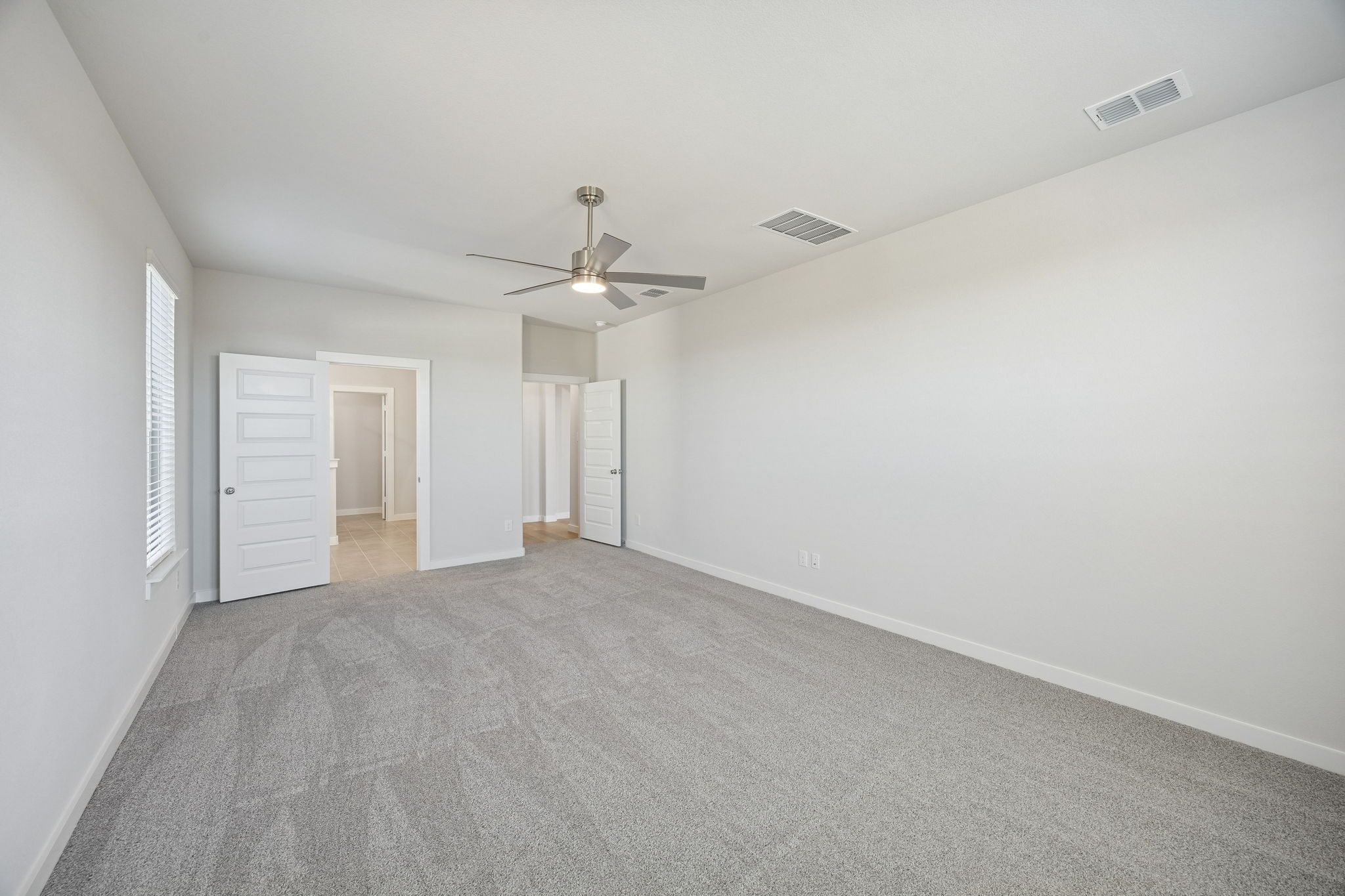 Primary Suite in the Wimbledon home plan by Trophy Signature Homes – REPRESENTATIVE PHOTO