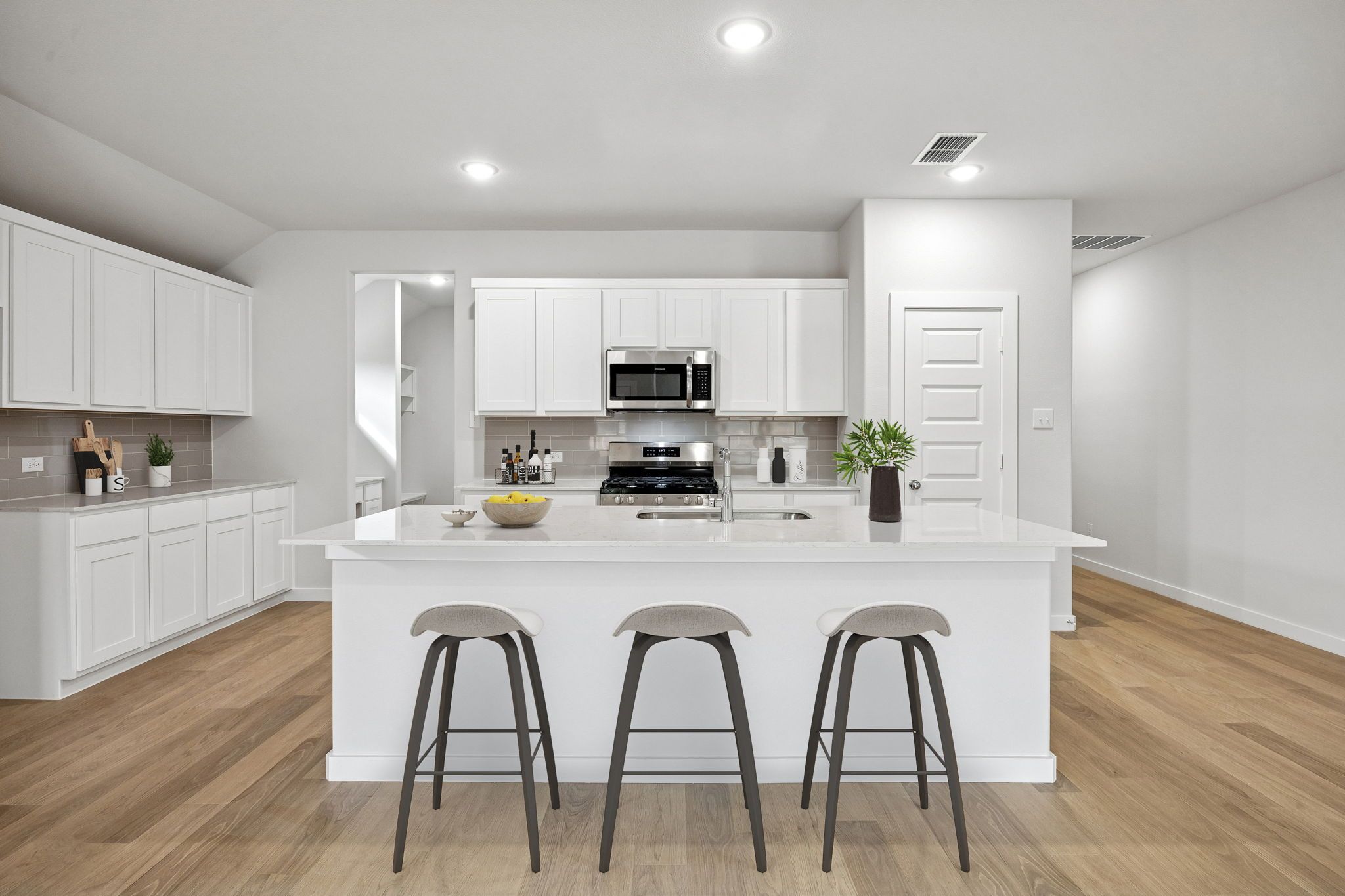 Kitchen in the Heisman home plan by Trophy Signature Homes - REPRESENTATIVE PHOTO
