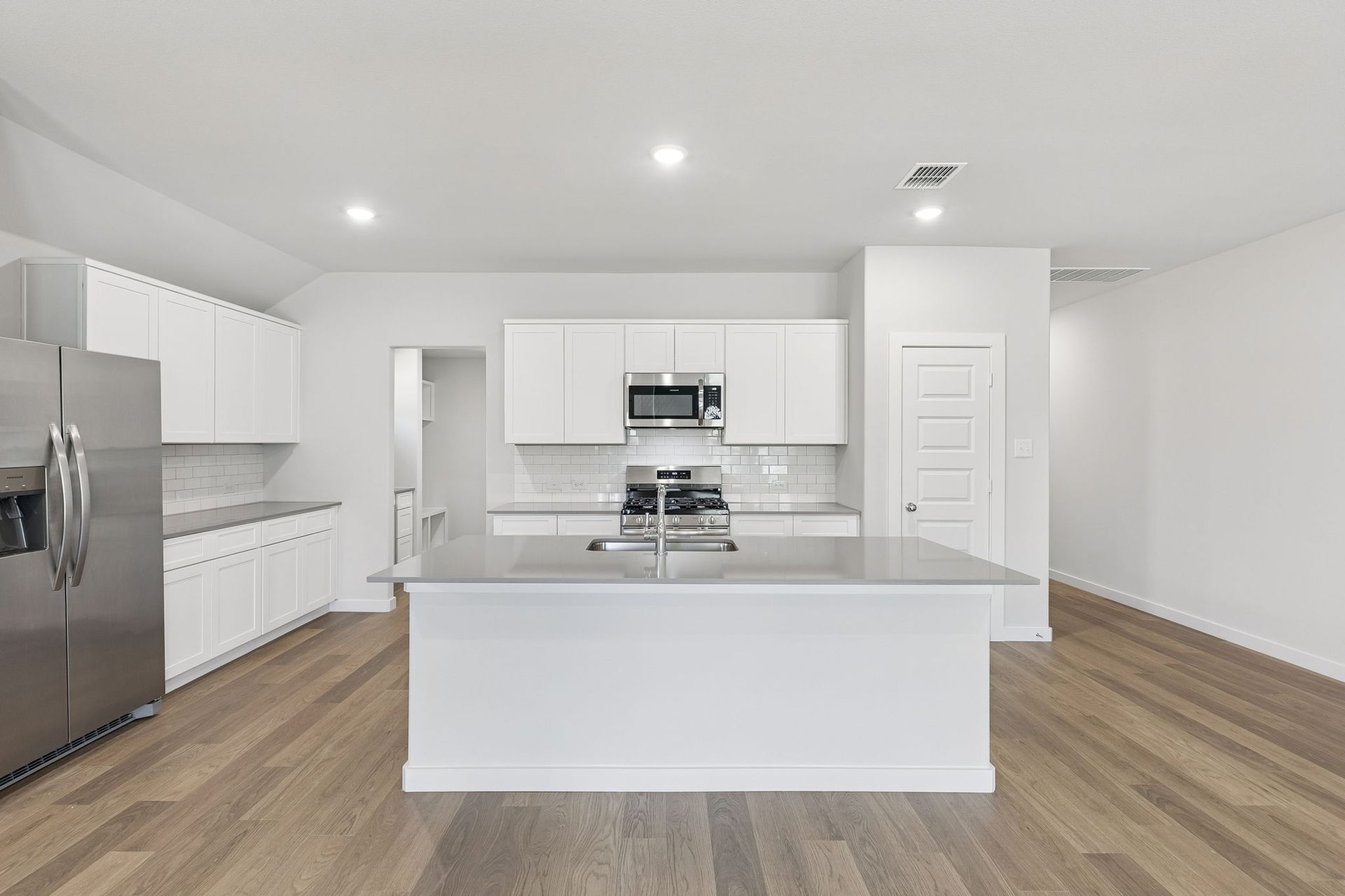 Kitchen in the Harrison home plan by Trophy Signature Homes – REPRESENTATIVE PHOTO
