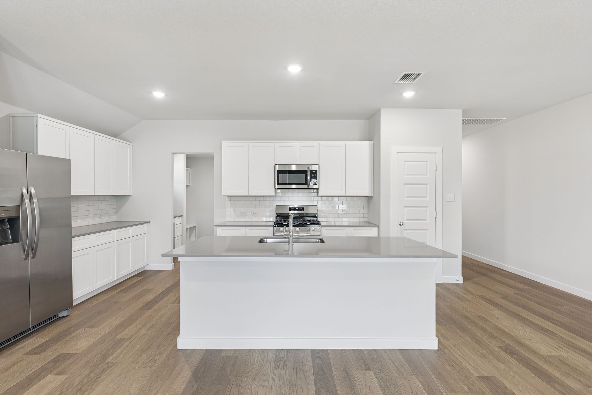 Kitchen in the Harrison home plan by Trophy Signature Homes – REPRESENTATIVE PHOTO