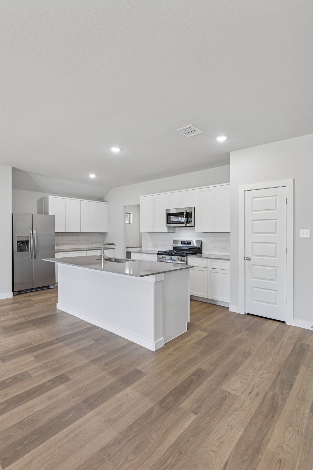 Kitchen in the Harrison home plan by Trophy Signature Homes – REPRESENTATIVE PHOTO