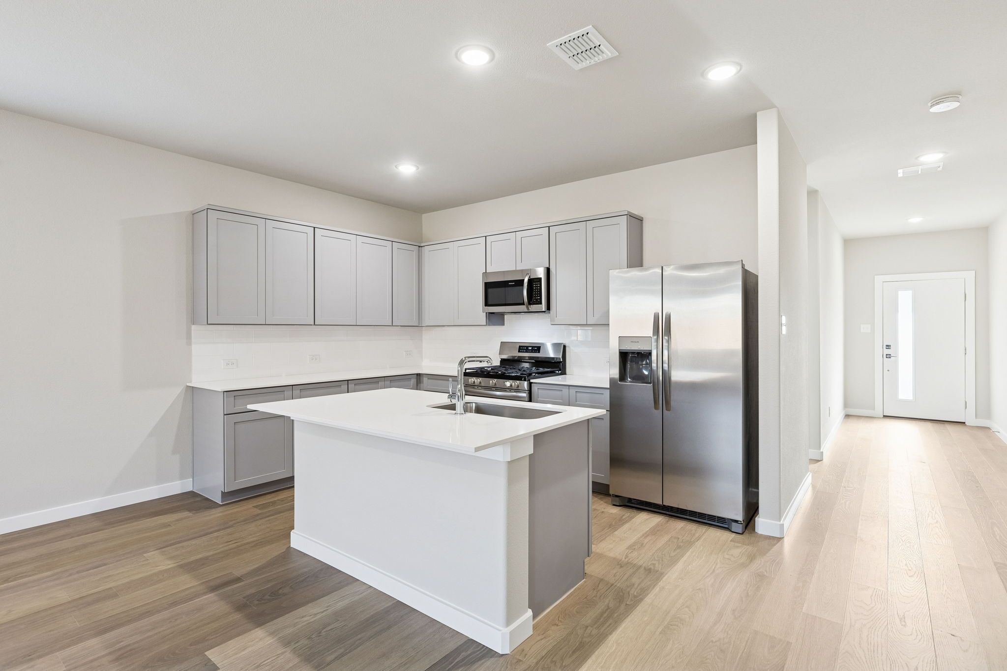 Kitchen in the Haylee home plan by Trophy Signature Homes - REPRESENTATIVE PHOTO