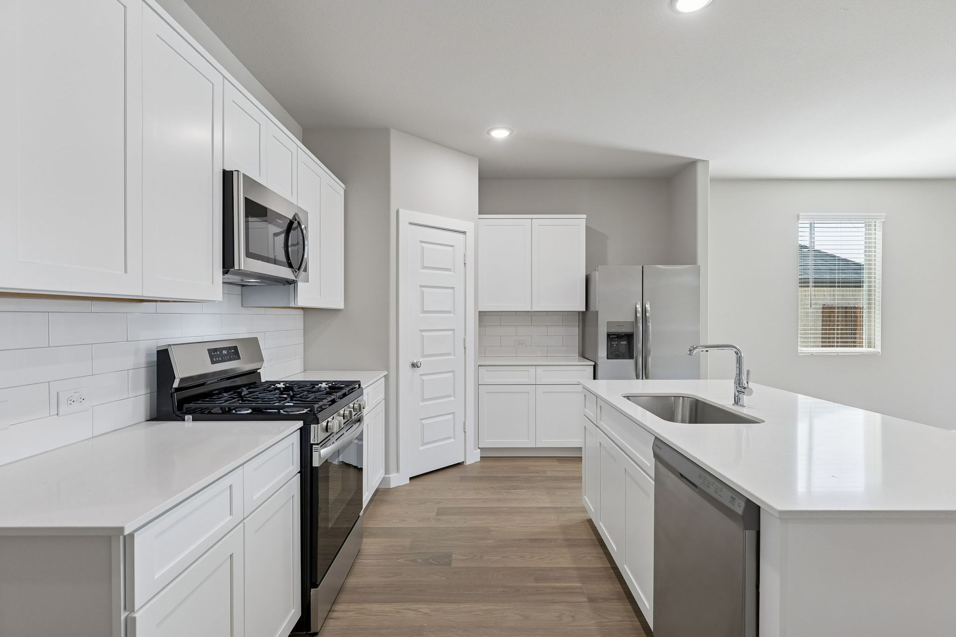 Kitchen in the Holden home plan by Trophy Signature Homes – REPRESENTATIVE PHOTO