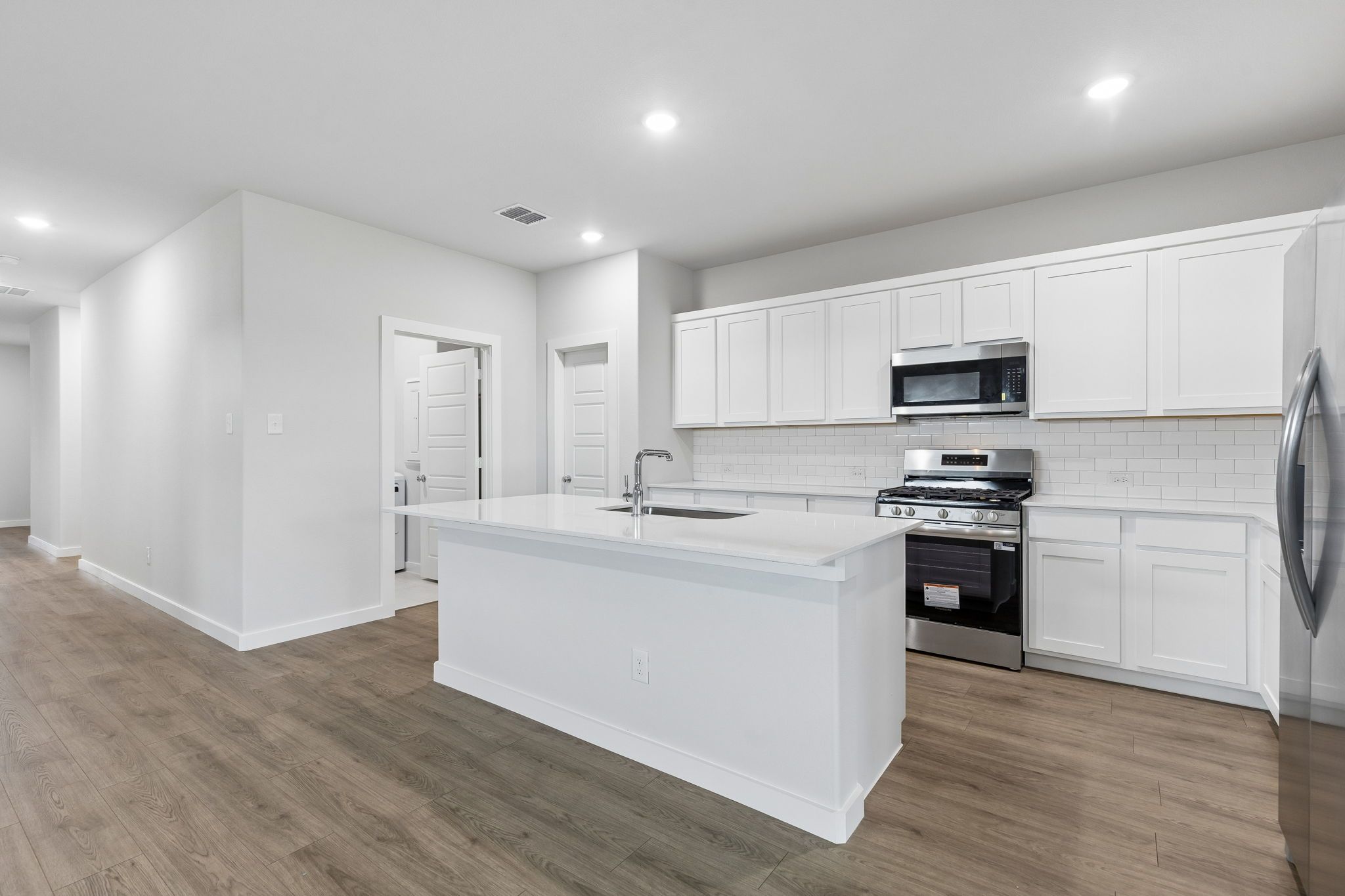 Kitchen in the Oscar home plan by Trophy Signature Homes – REPRESENTATIVE PHOTO