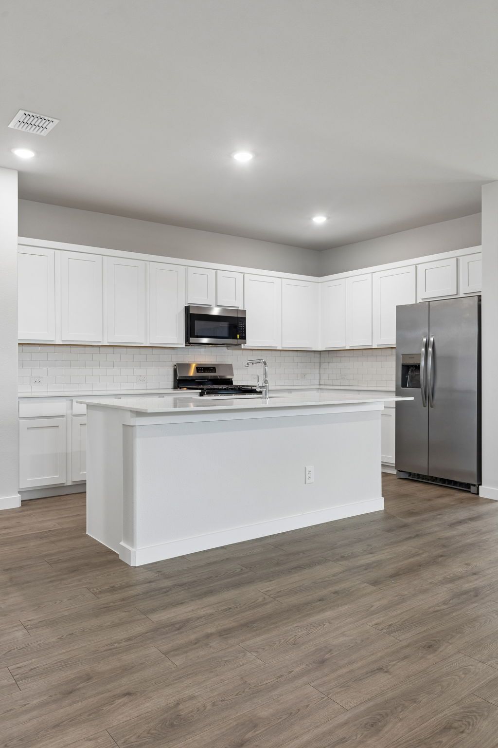 Kitchen in the Oscar home plan by Trophy Signature Homes – REPRESENTATIVE PHOTO