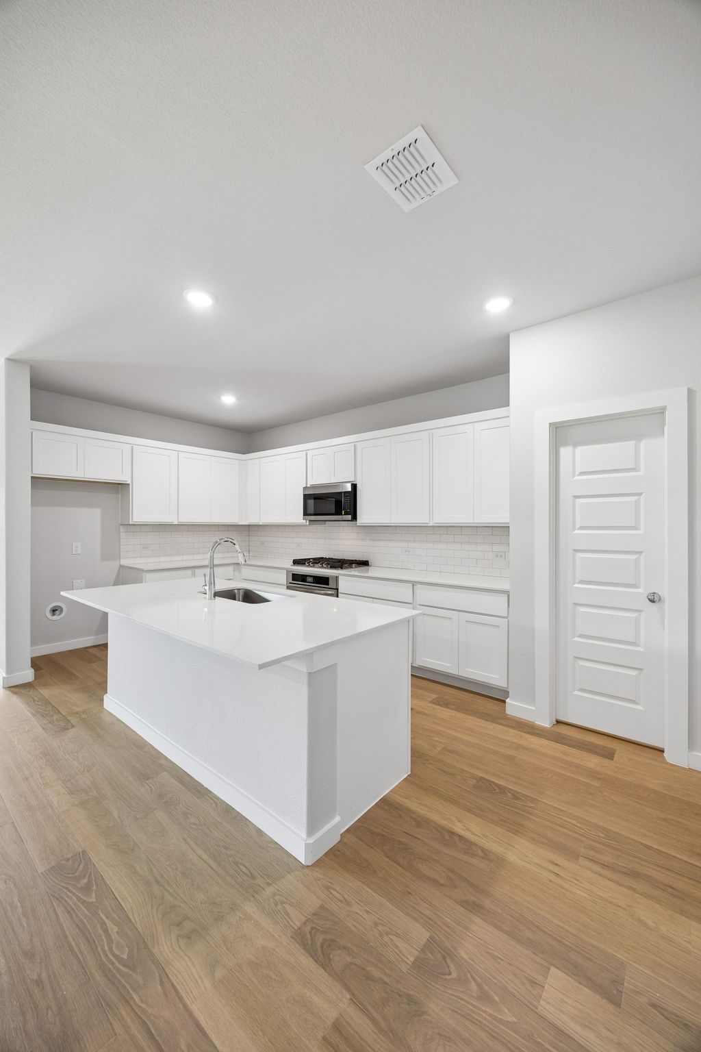 Kitchen in the Oscar home plan by Trophy Signature Homes – REPRESENTATIVE PHOTO