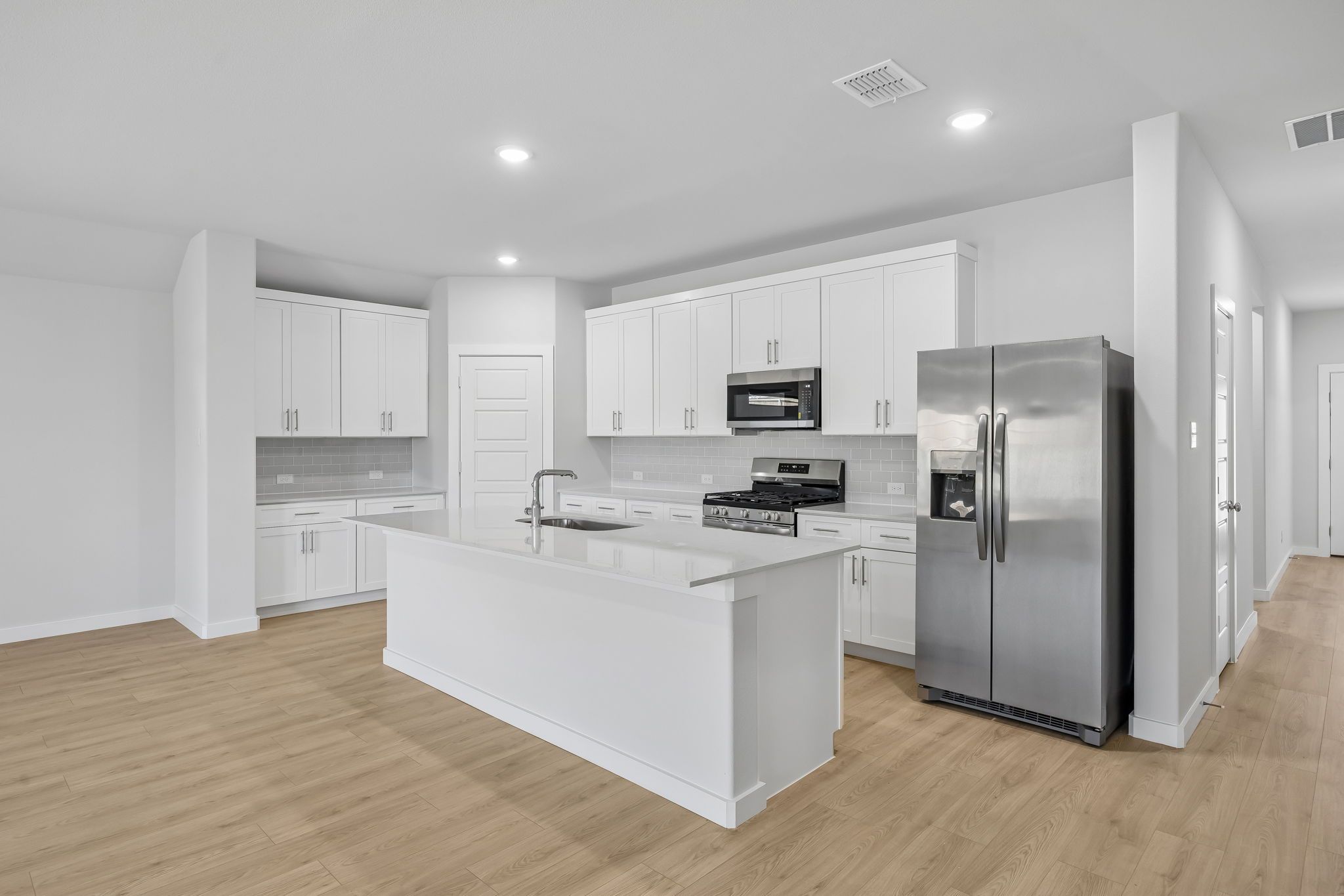 Kitchen in the Heisman home plan by Trophy Signature Homes – REPRESENTATIVE PHOTO
