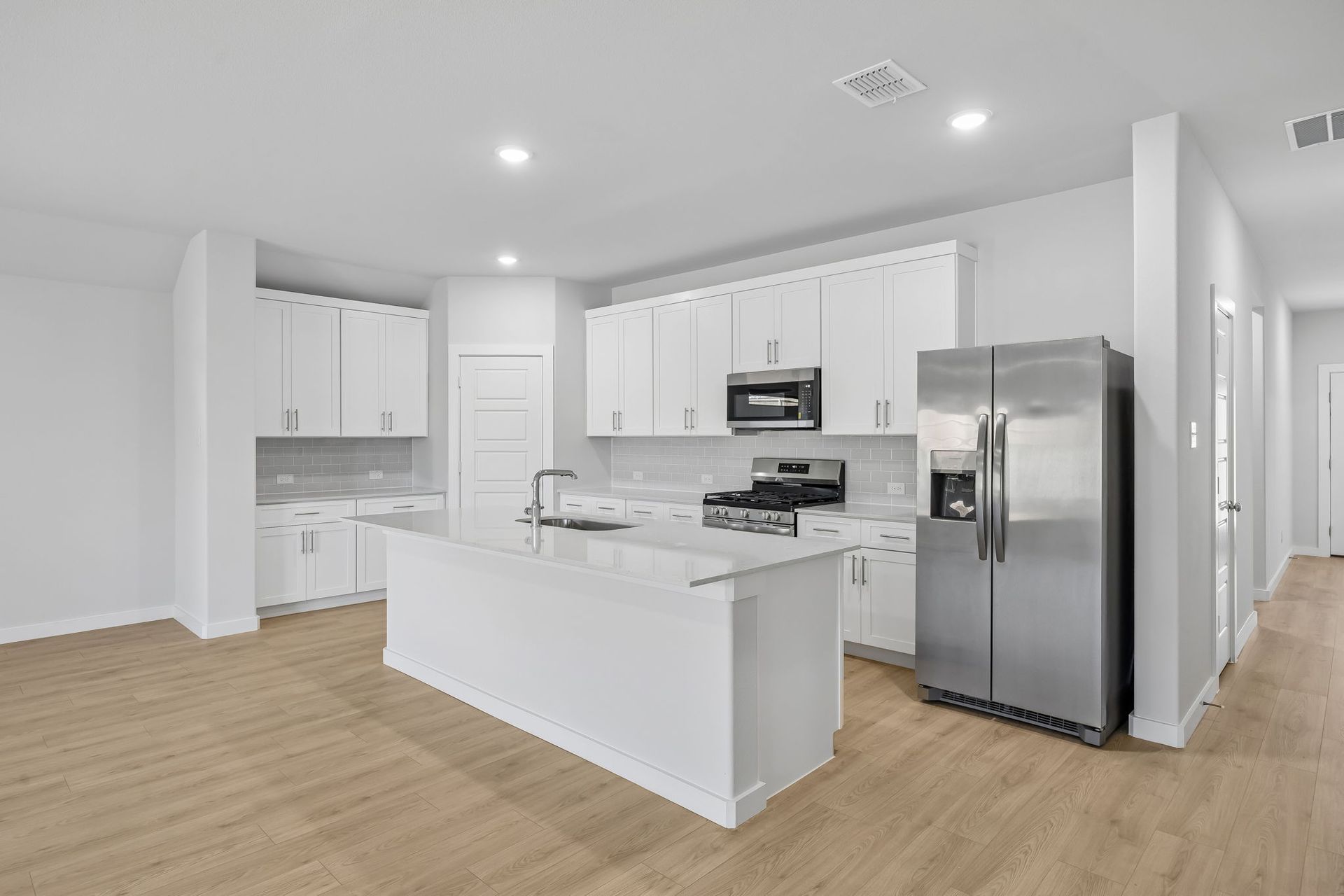 Kitchen in the Heisman home plan by Trophy Signature Homes – REPRESENTATIVE PHOTO