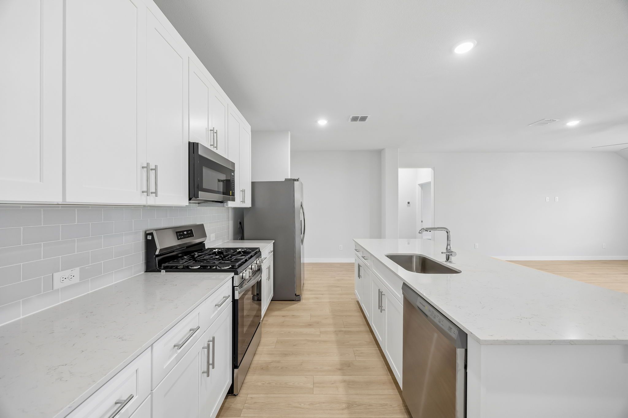 Kitchen in the Heisman home plan by Trophy Signature Homes – REPRESENTATIVE PHOTO