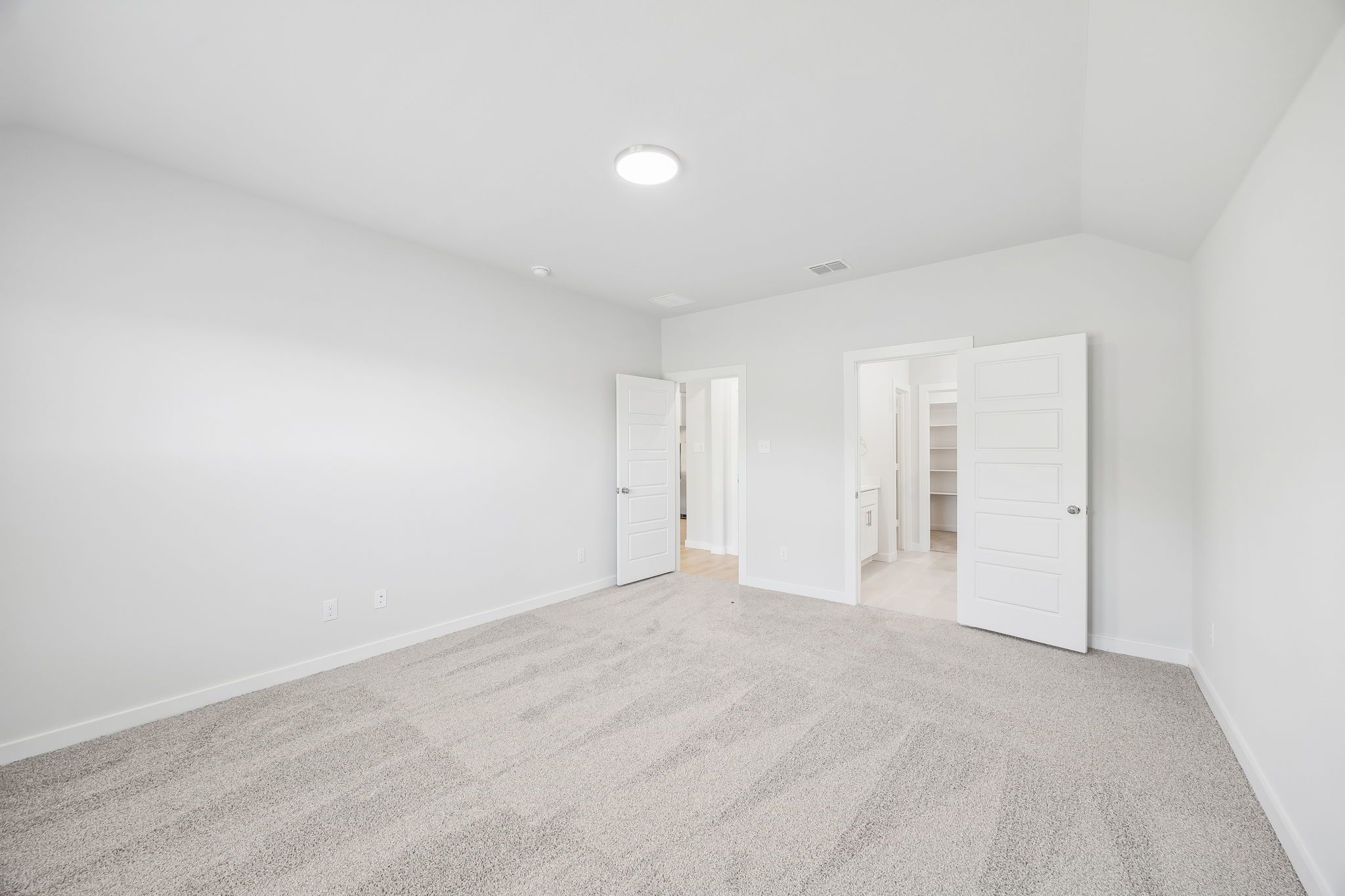 Primary bedroom in the Heisman home plan by Trophy Signature Homes – REPRESENTATIVE PHOTO