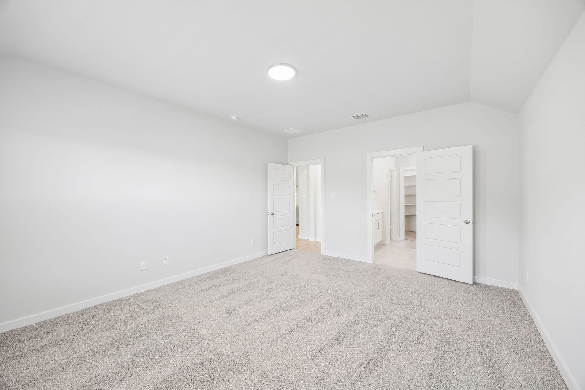 Primary bedroom in the Heisman home plan by Trophy Signature Homes – REPRESENTATIVE PHOTO