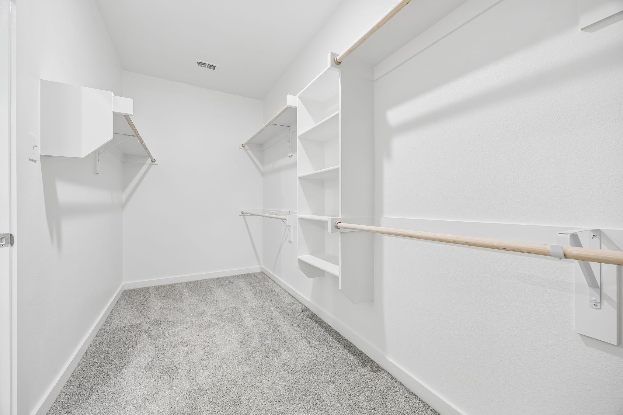 Walk-in closet in the Heisman home plan by Trophy Signature Homes – REPRESENTATIVE PHOTO