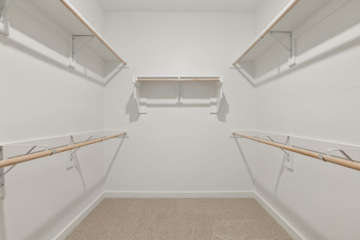 Primary Closet in the Masters home plan by Trophy Signature Homes – REPRESENTATIVE PHOTO
