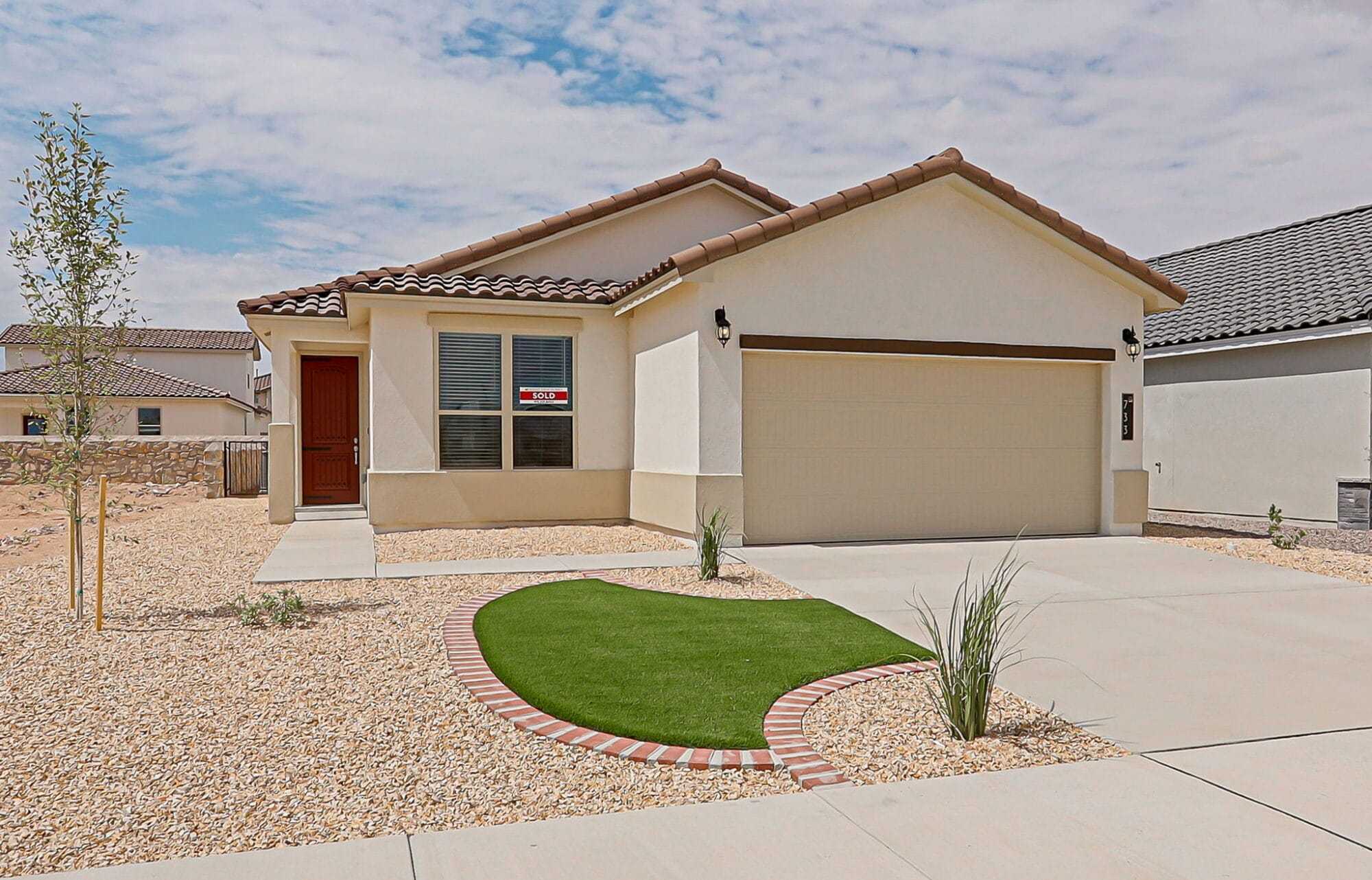 The Desert Willow floorplan showcasing its exterior design and professionally landscaped front yard with rock and turf.