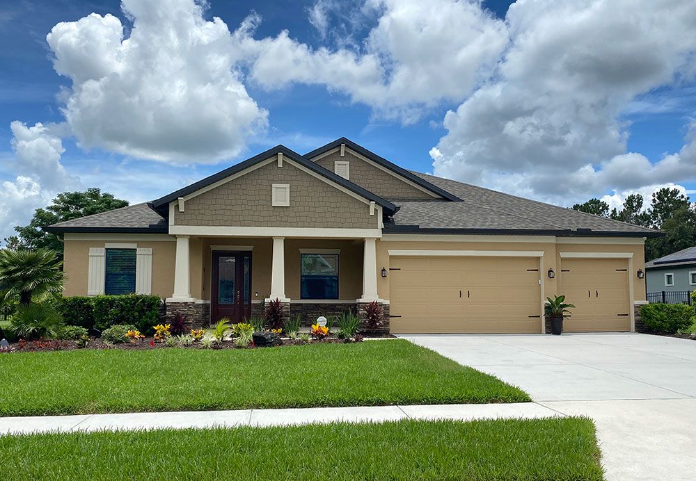 Joyce craftsman with opt stone new home front exterior William Ryan Homes Tampa