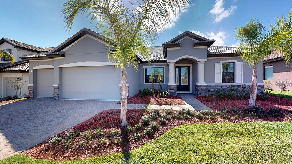 Carlingford elevation 3 with stone and barrel roof options available at Whiting Estates in Spring Hill, FL new home construction by William Ryan Homes Tampa