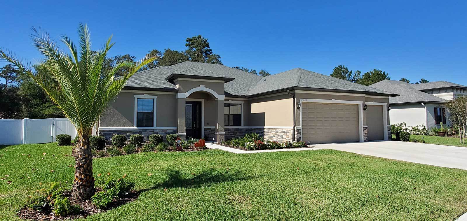 Carlingford elevation three with stone plan available at Whiting Estates in Spring Hill FL new home construction by William Ryan Homes Tampa