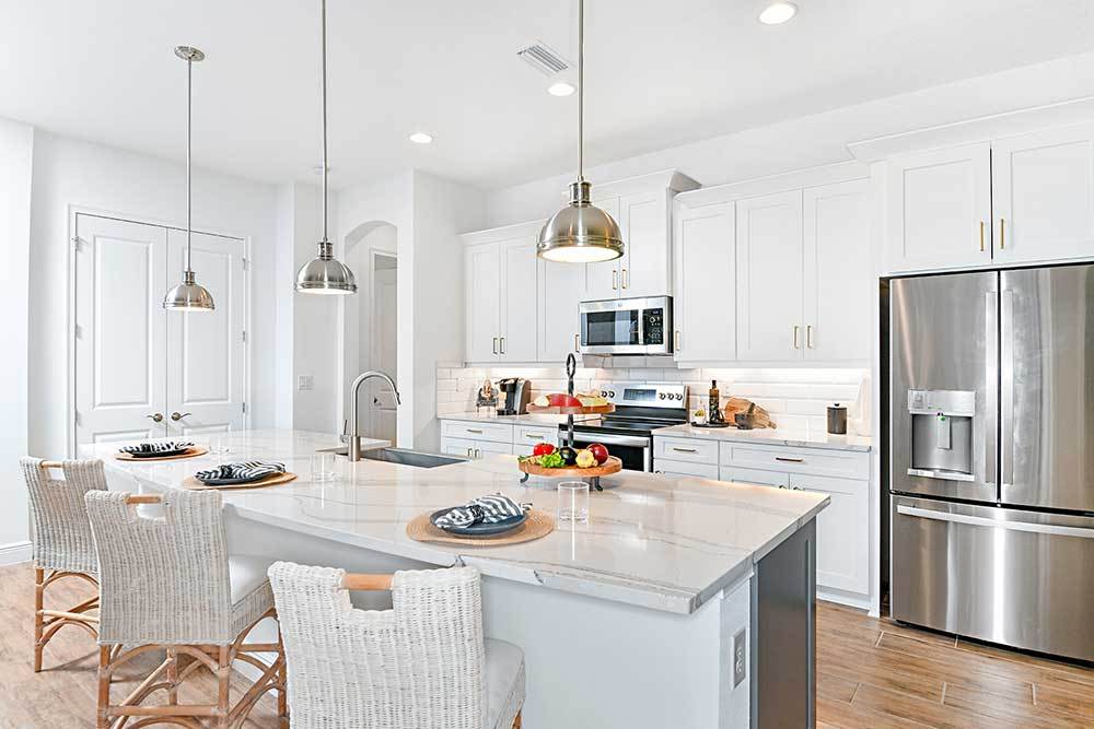 Joyce model home kitchen with large island by William Ryan Homes Tampa