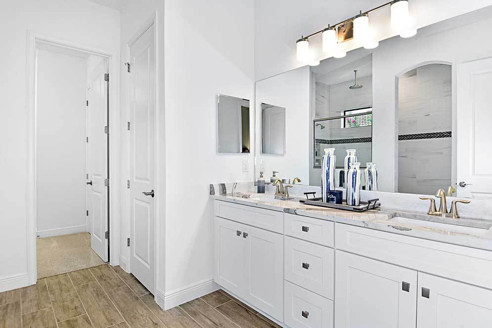Joyce model home owners bathroom dual sink vanity and private commode William Ryan Homes Tampa