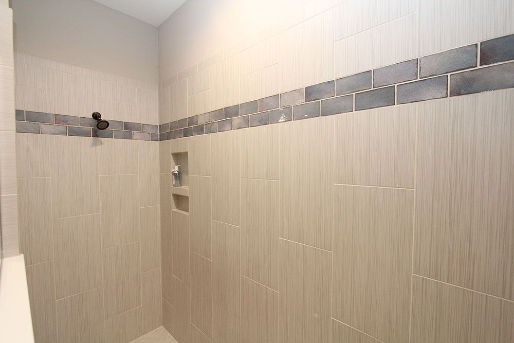 Sweetwater model home plan tile detail in owners bath roman shower by William Ryan Homes Tampa
