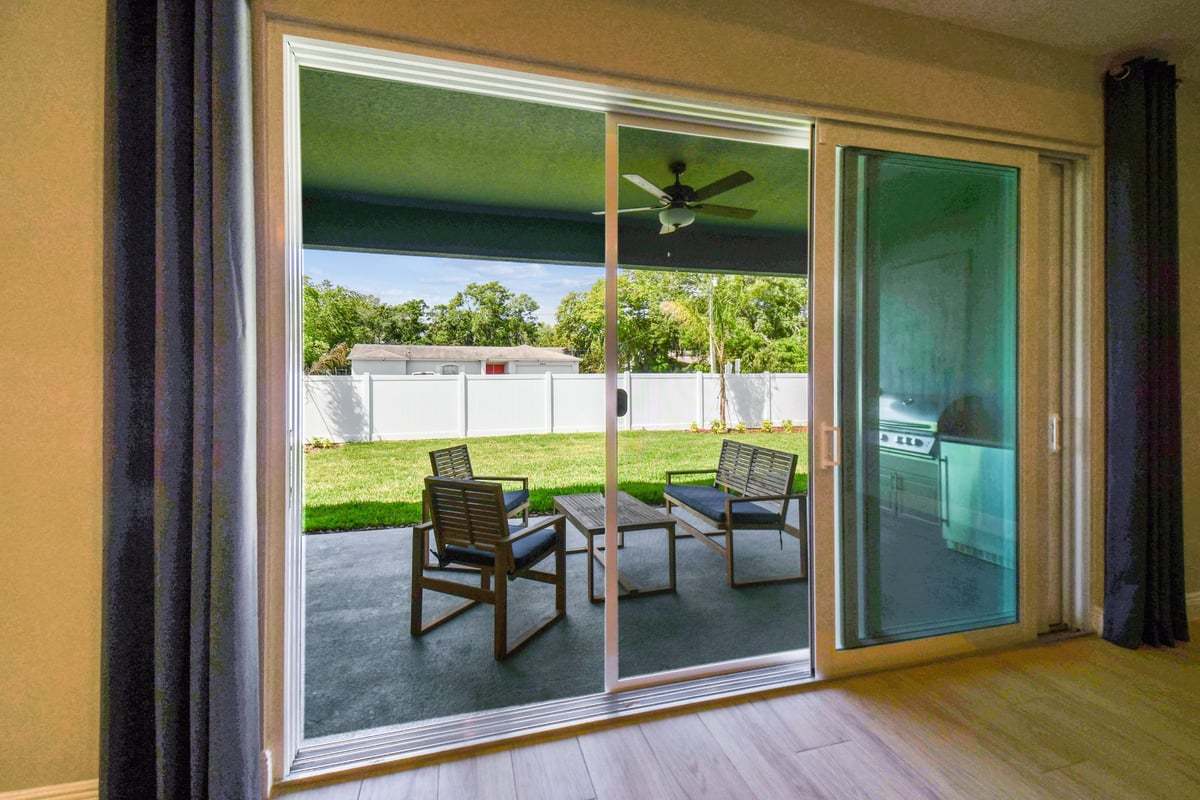 Charlotte new construction home plan optional triple sliders to outdoor living space lanai by William Ryan Homes Tampa