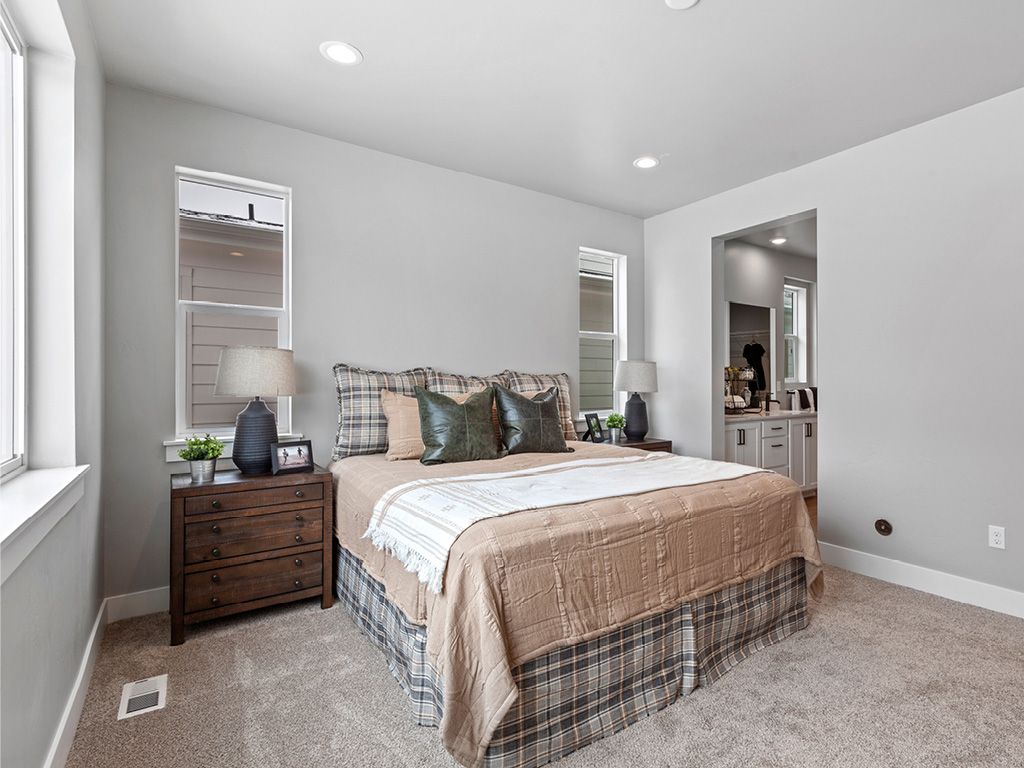Inviting primary bedroom showcasing top home builder expertise in new homes for sale