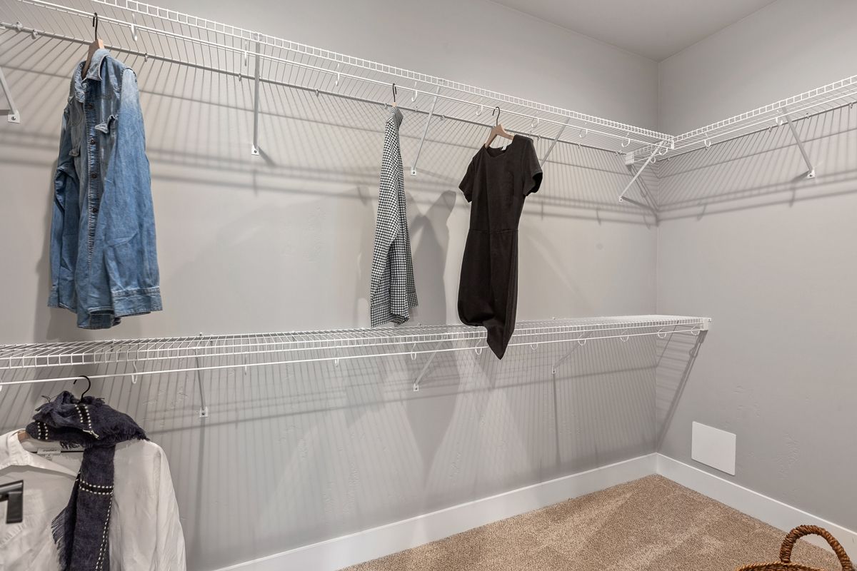 Well-organized walk-in closet in new homes for sale by top home builder