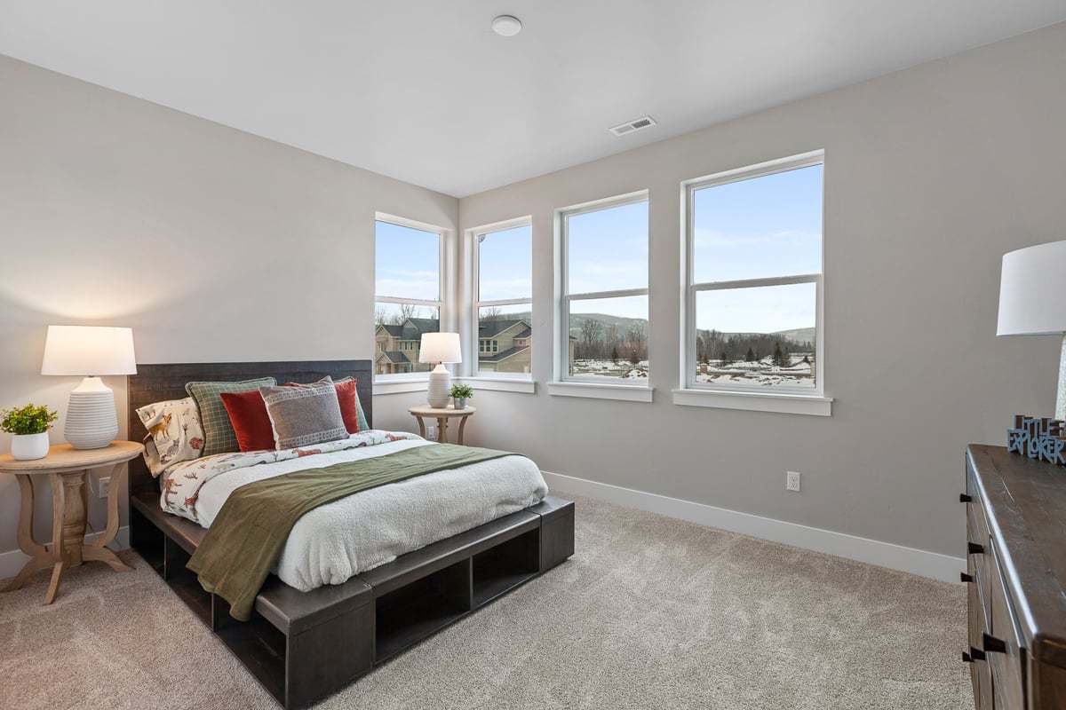 Comfortable primary bedroom by top home builder in new homes for sale