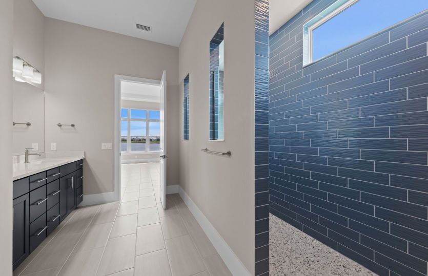 Owners bathroom with dual sinks and walk in shower