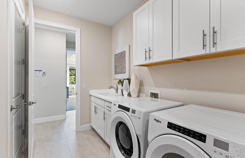 Laundry room with cabinets and sink