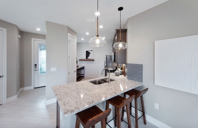 Kitchen with stainless steel appliances and decorative backsplash
