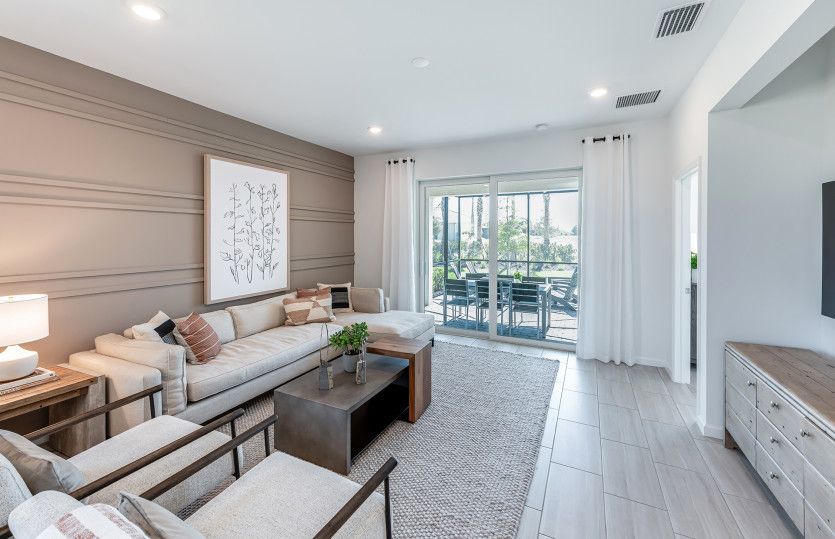 Open gathering room with sliding glass doors to the covered lanai