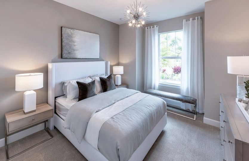 Secondary bedroom in front of home with closet