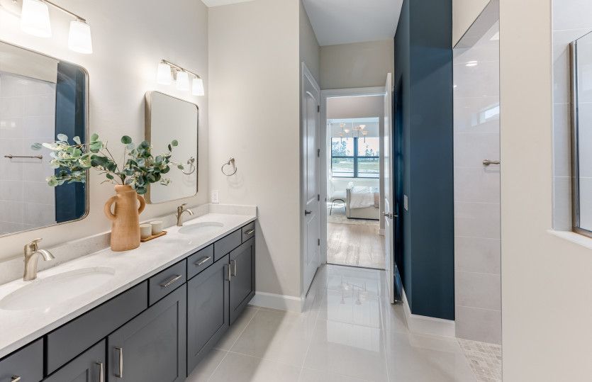Owner's bathroom with double sink vanity and walk-in shower