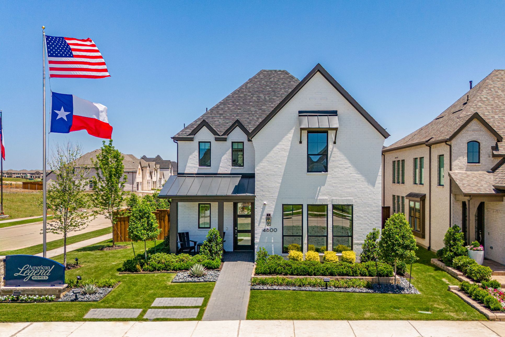 American Legend Homes 40-foot model home exterior in Mosaic Celina TX with manicured landscaping ...:40’ Model Home Exterior at Mosaic Community in Celina TX