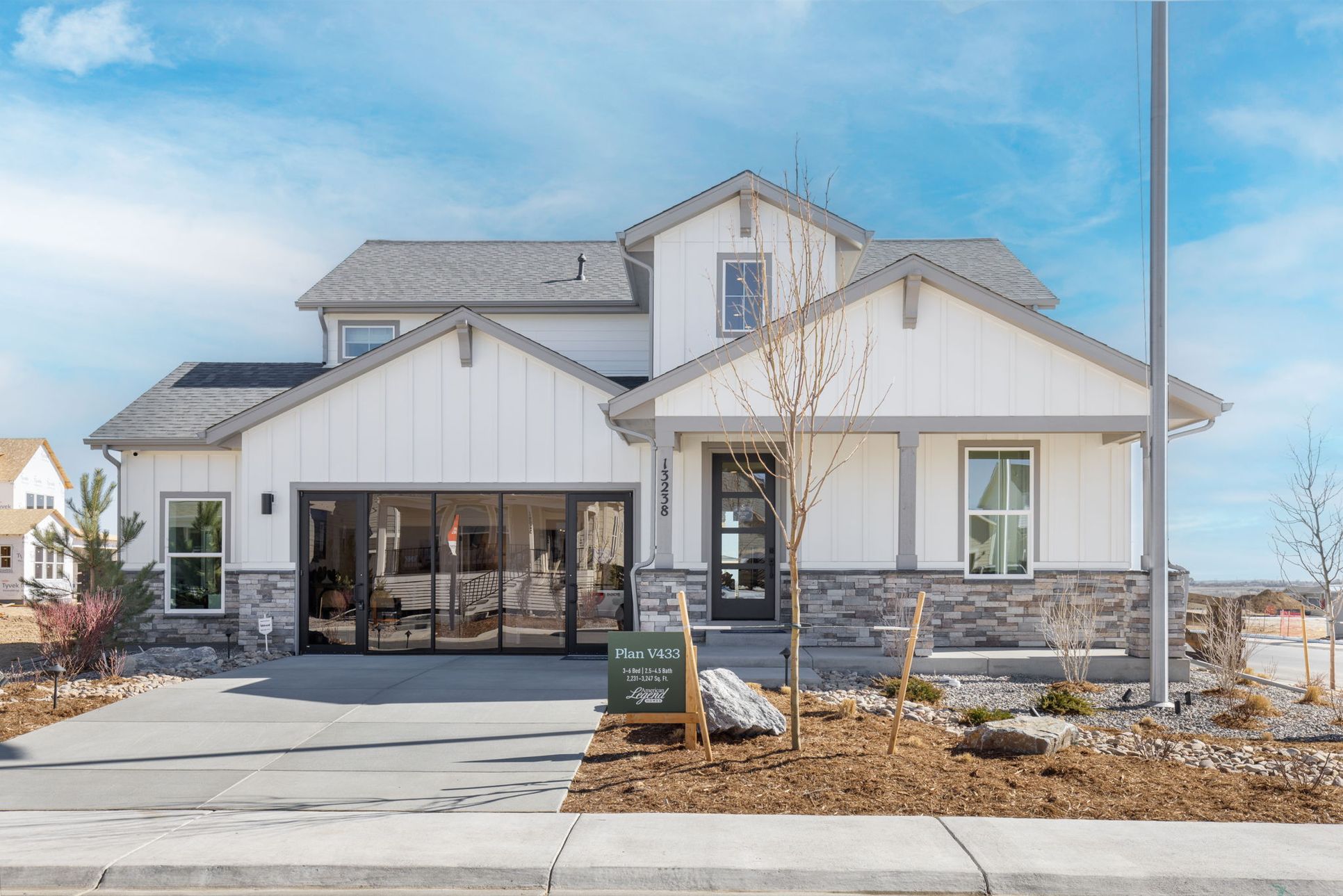Modern farmhouse-style new construction home in Barefoot Village, Firestone Colorado featuring wh...:Modern Farmhouse Exterior in Barefoot Village – Firestone CO New Construction Home