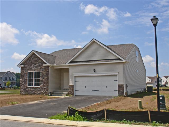 Windsor at Pinehurst Front:Windsor includes 2 car garage, stone accents, carriage style doors