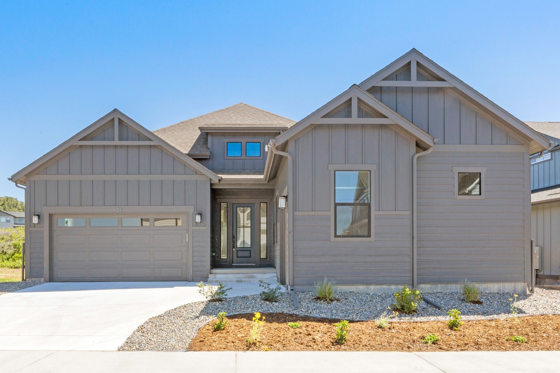 Modern Grey House with Gabled Roof and Double Garage in Montaine:Elegant gabled roof and expansive windows define this exquisite Montaine residence. Precision-crafted façade.