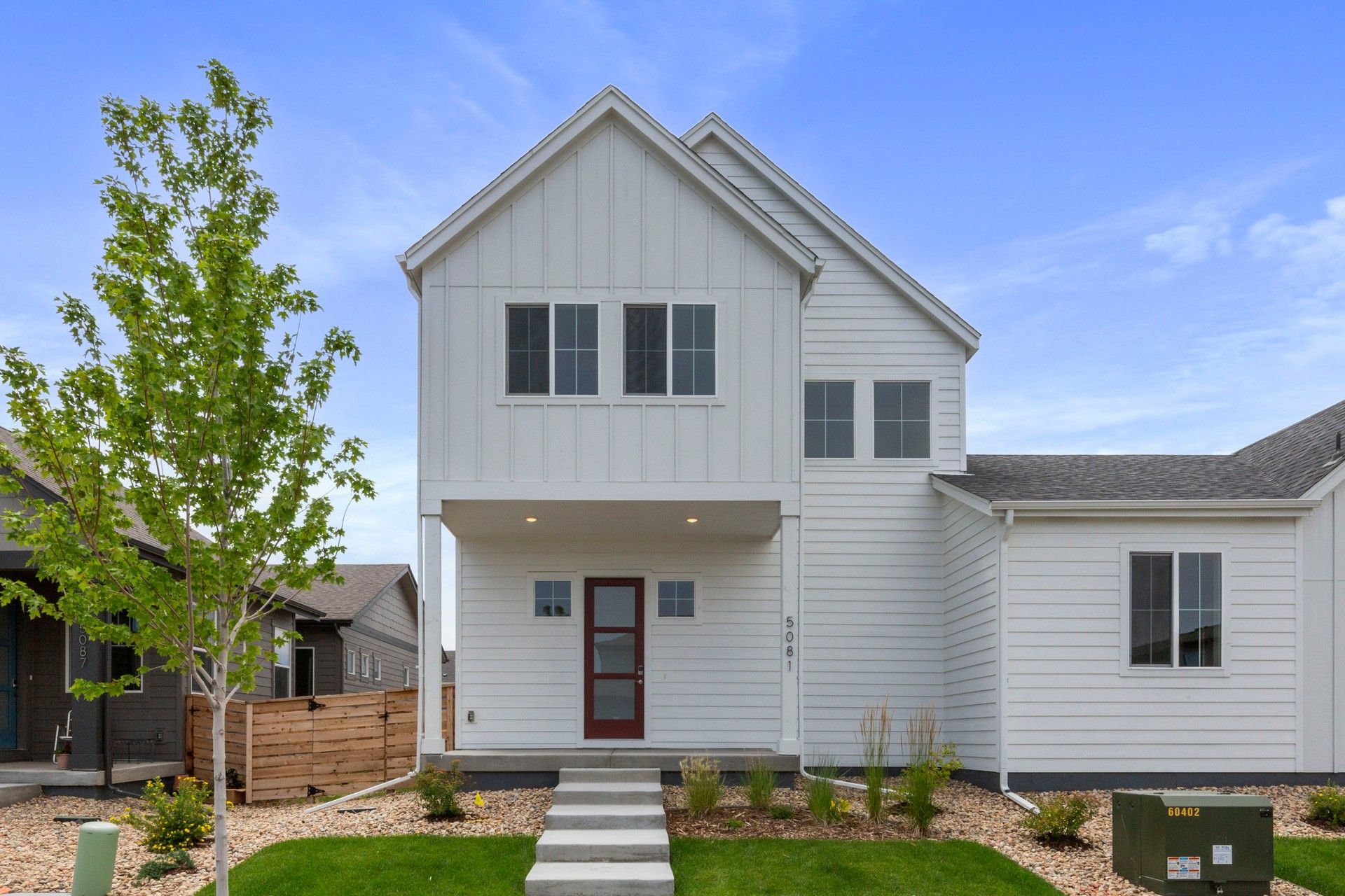 Modern Farmhouse with Board-and-Batten at Trailside on Harmony:Elegant board-and-batten siding enhances this sophisticated Trailside on Harmony residence.