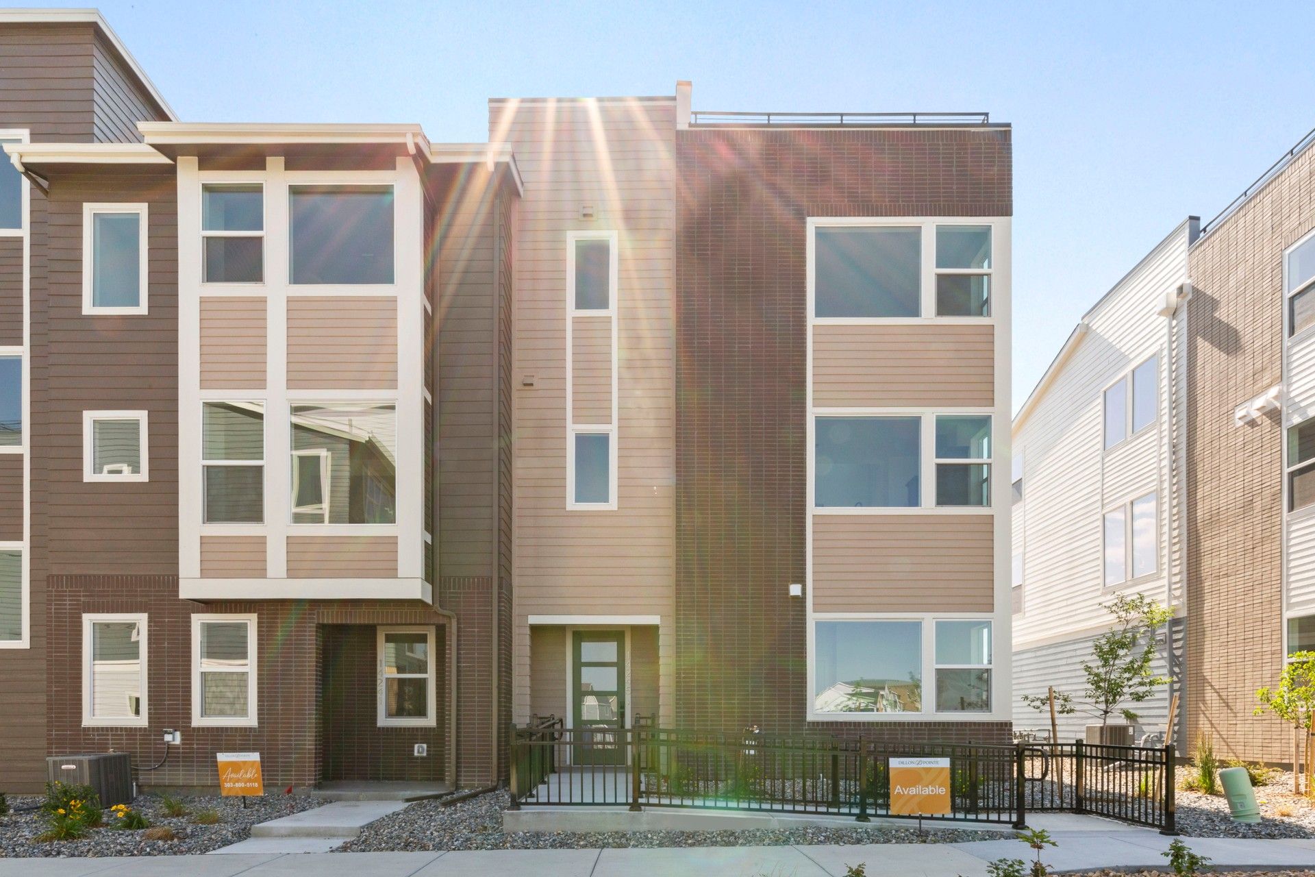 Contemporary Townhouse at Dillon Pointe with Brick Design:Luxurious three-story townhouse with expansive windows and elegant brickwork at Dillon Pointe.