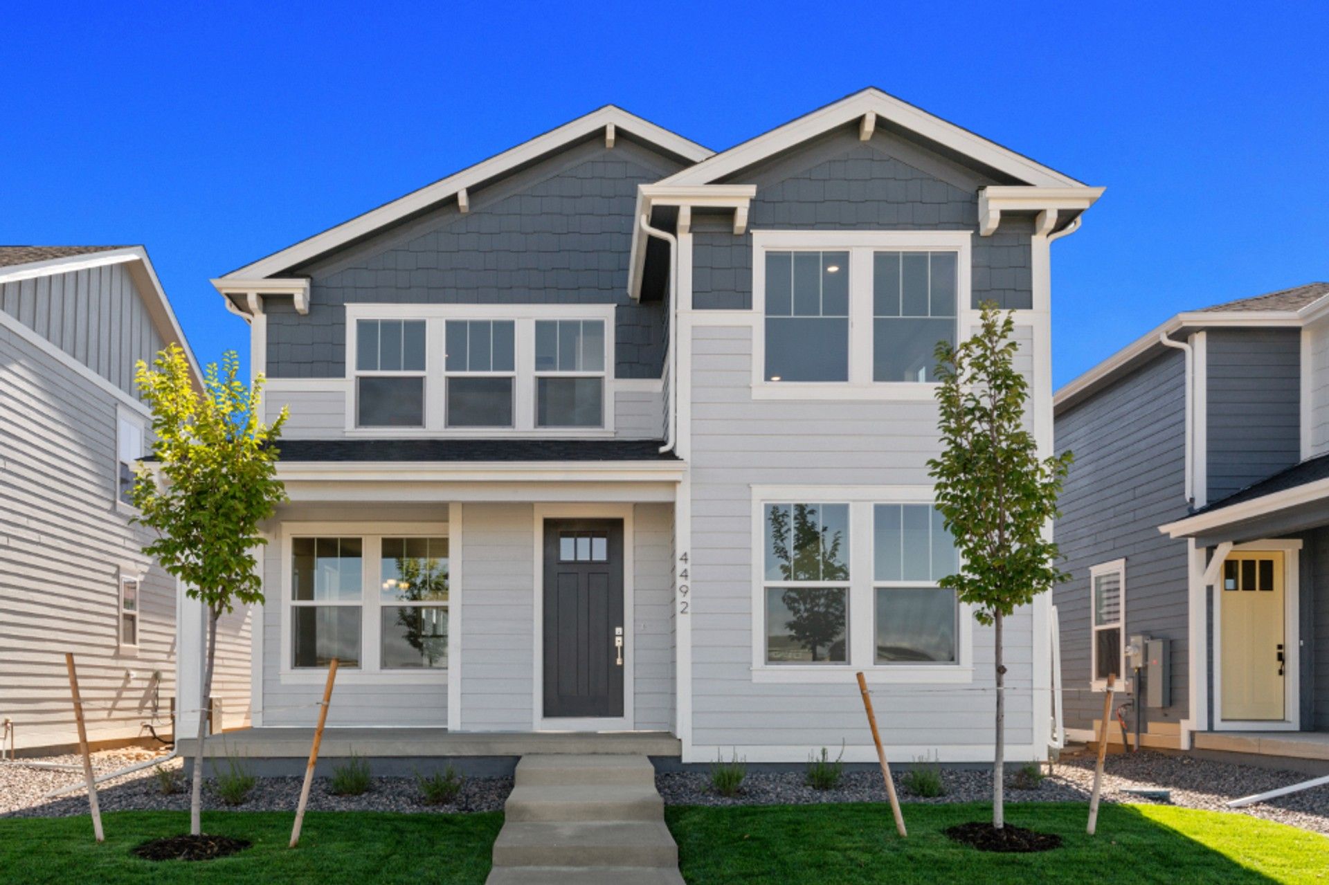 Modern Two-Story Home at Timnath Lakes:This Timnath Lakes residence boasts a sleek gabled roof design and expansive windows.