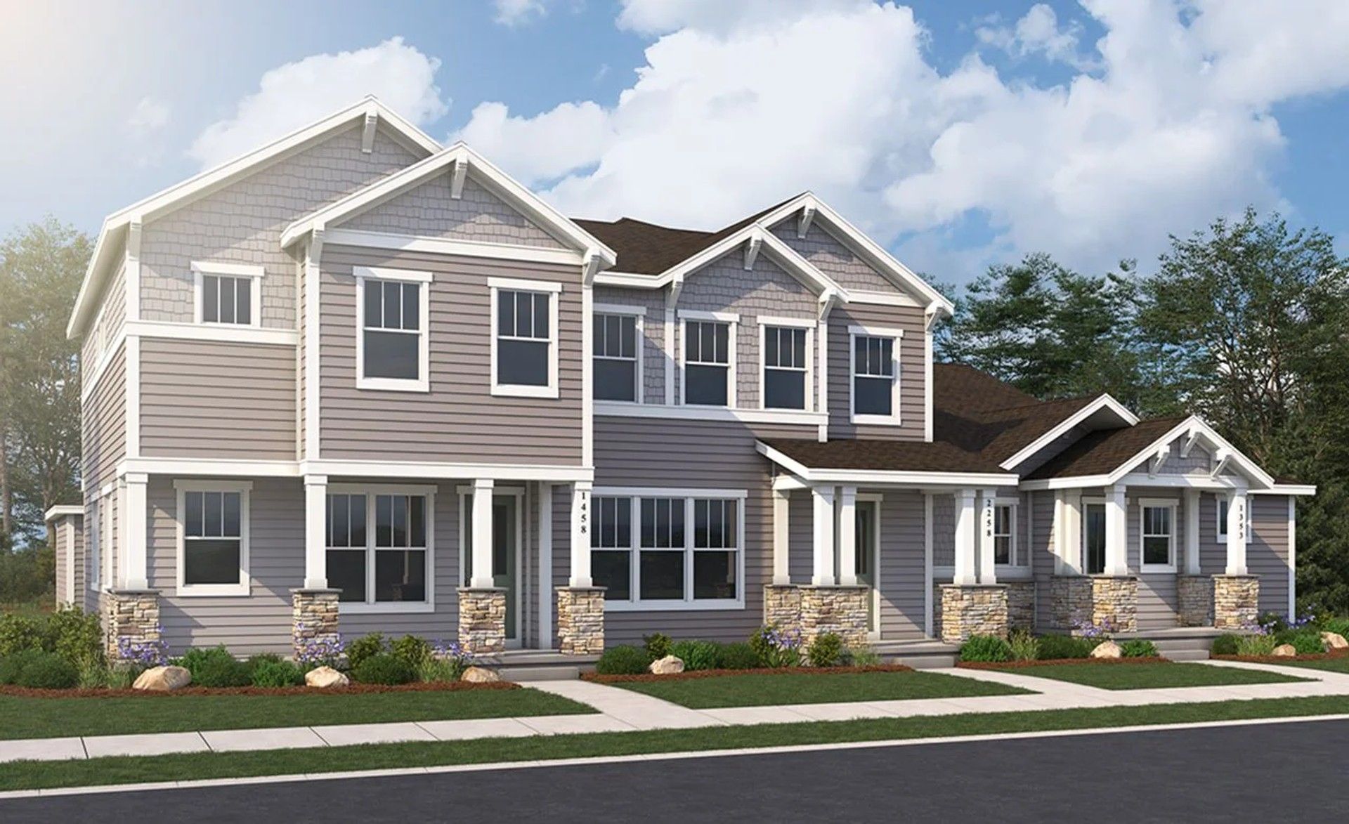 Westerly Townhomes Featuring Stone Columns and Gray Siding:Luxury Westerly townhome showcases exquisite stone columns and refined gray facade amidst verdant landscaping.