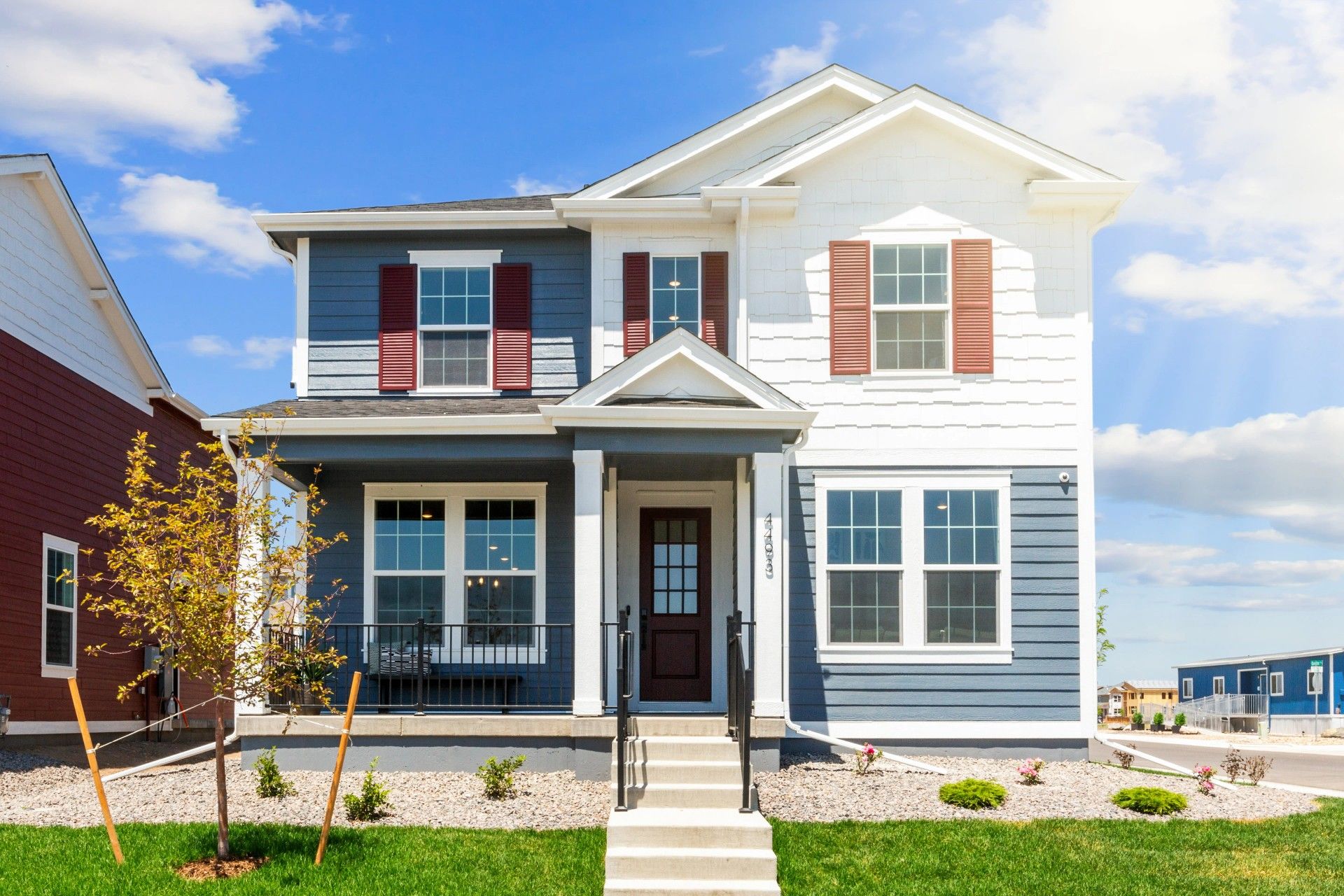 Two-Story House with Blue Siding in Timnath Lakes:Stunning blue and white exterior with classic pergola entry. Located in the sought-after Timnath Lakes.