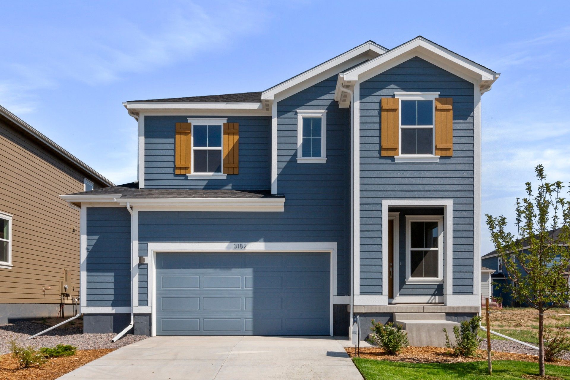 Modern Blue Two-Story Home with Garage in Countryside Setting:Experience luxury in this blue two-story home with elegant white trim and large windows, nestled in serene countryside.
