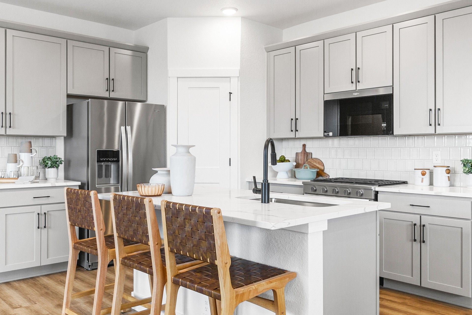 Contemporary kitchen with gray cabinetry and island in Falcon, Colorado home.:Elegant marble island and sleek gray cabinetry define this Falcon, Colorado kitchen.